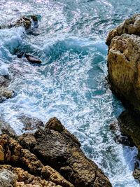 High angle view of rocks in sea