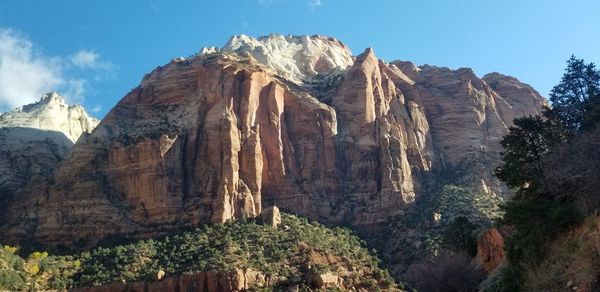 Low angle view of rocks on mountain against sky