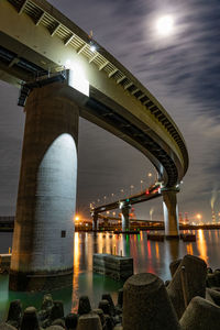 View of bridge over river at night