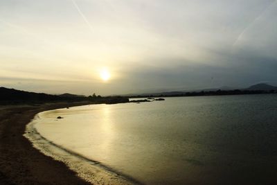 Scenic view of beach against sky during sunset