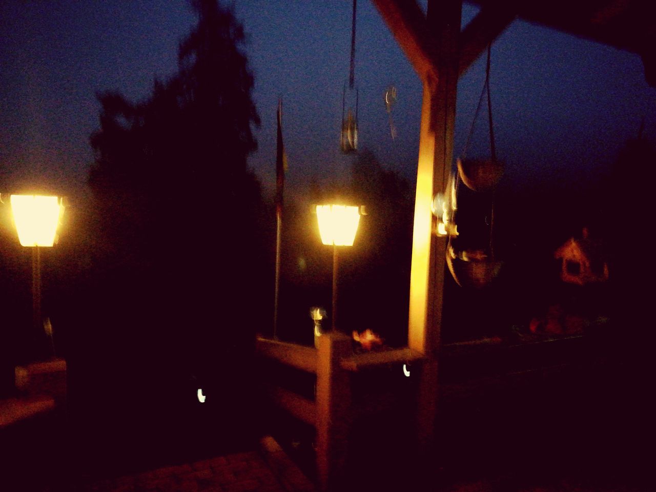 ILLUMINATED LAMP POST AGAINST STAR FIELD AT NIGHT