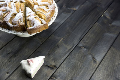 High angle view of pie and cakes on wooden table