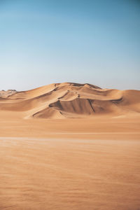 Scenic view of desert against clear sky