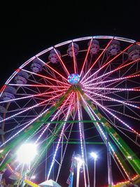 Low angle view of ferris wheel against sky at night