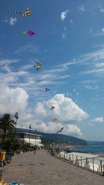 Airplane flying over beach against sky