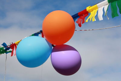 Low angle view of balloons against sky