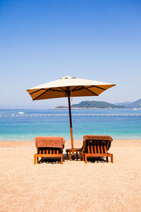 Lifeguard chair on beach against clear sky