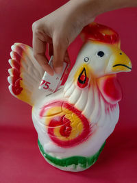 Save money by using a piggy bank in the shape of a rooster