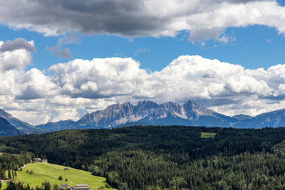 Scenic view of mountains against cloudy sky