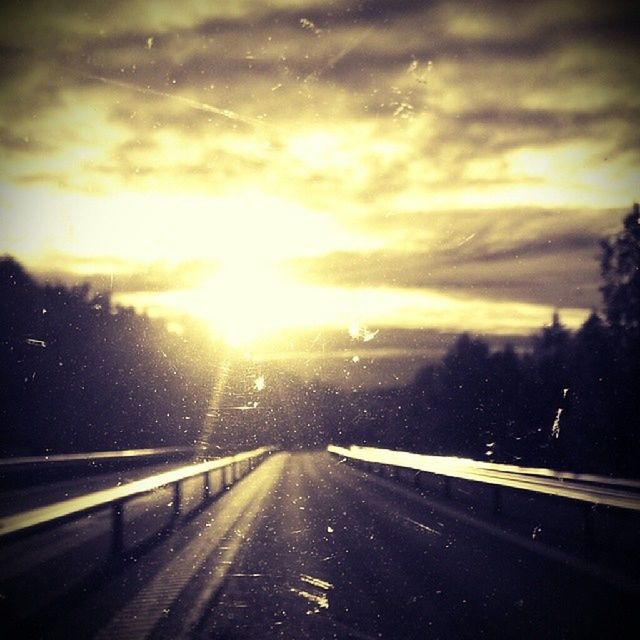 transportation, road, the way forward, sky, sunset, car, weather, diminishing perspective, cloud - sky, sun, land vehicle, street, tree, road marking, wet, vanishing point, nature, mode of transport, sunlight, country road