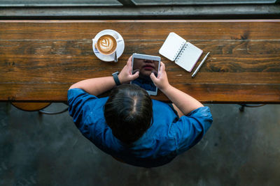 Directly above view of man using mobile phone