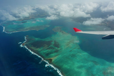 Aerial view of seascape against cloudy sky