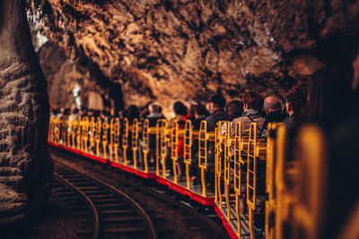 People on railroad tracks against trees