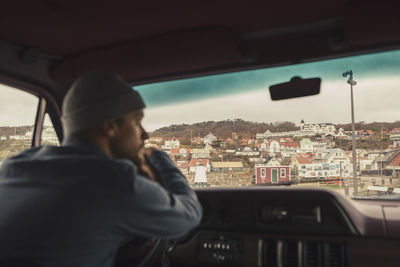 Contemplative man driving camping van