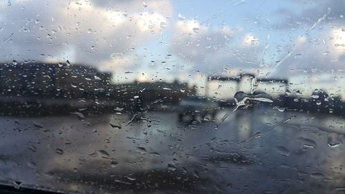 Full frame shot of wet glass window in rainy season