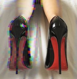 Low section of woman wearing multi colored shoes