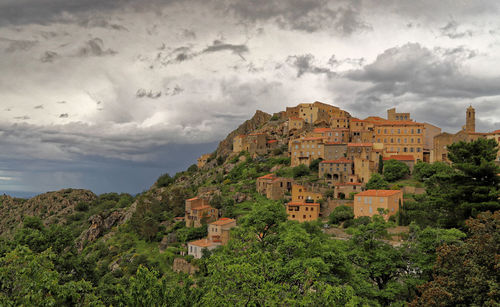 Buildings in town against sky