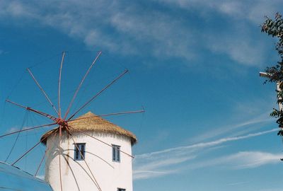 Low angle view of traditional windmill against sky