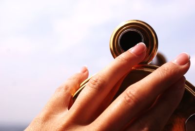 Close-up of human hand on binoculars. sightseeing and tourism concept.