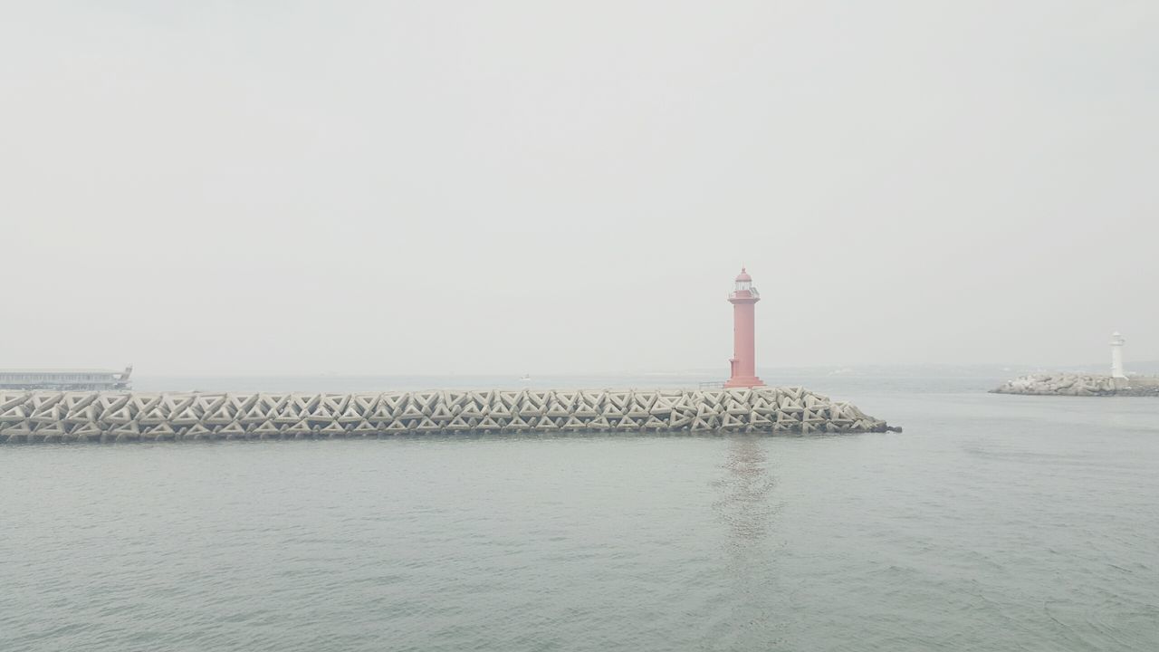 lighthouse, sea, guidance, water, built structure, architecture, direction, protection, safety, horizon over water, security, tower, tranquility, tranquil scene, nature, day, sky, rippled, scenics, outdoors, no people, ocean, calm, beauty in nature, idyllic, travel destinations