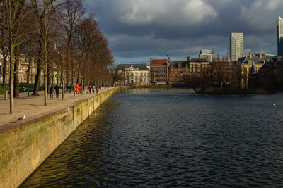 River amidst buildings in city against sky