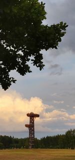 Cross on field against sky during sunset