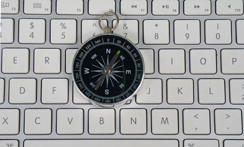 Close-up of compass on laptop keyboard