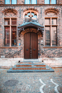 Elevation view of the historic building entrance showing the front door with the steps.