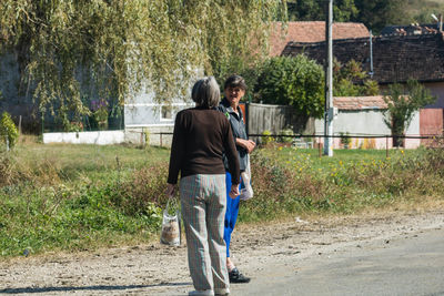 Rear view of people walking outdoors