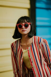 Portrait of woman wearing sunglasses standing outdoors