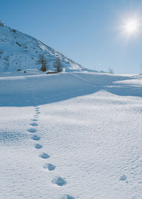 Snow covered landscape against sky