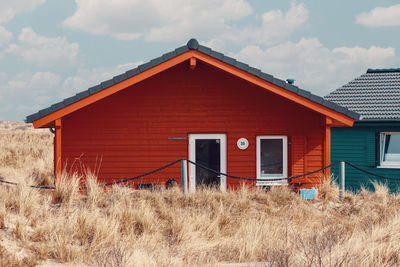 Exterior of house on field against sky