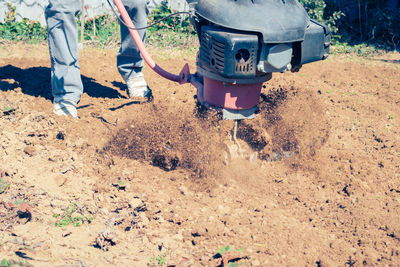 Low section of man working at beach