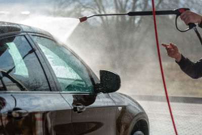 Man holding glass of car