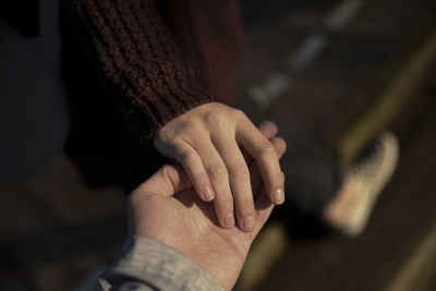 Close-up of couple holding hands