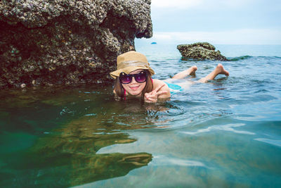 Portrait of woman swimming in sea