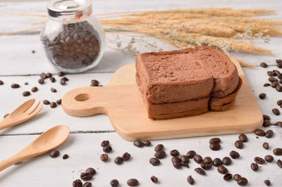 High angle view of breads and coffee beans on table