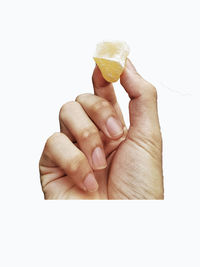 Midsection of person holding ice cream against white background