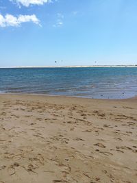 Scenic view of beach against clear blue sky