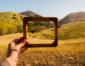 Cropped image of person standing on grassy field