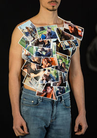 Close-up of man holding hands over black background