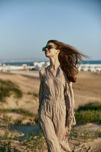 Young woman standing at beach