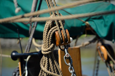 Close-up of rope tied up on metal chain