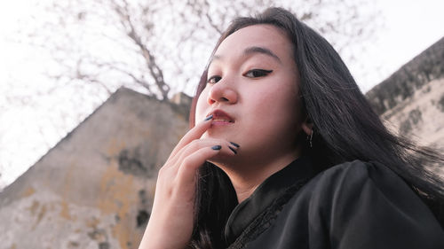 Portrait of beautiful young woman looking away