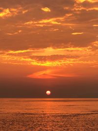 Scenic view of sea against romantic sky at sunset