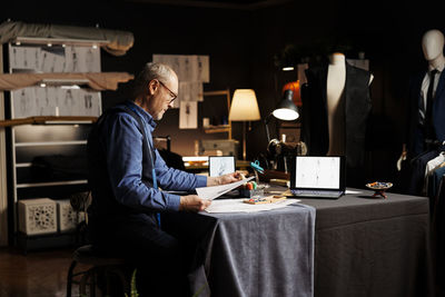 Rear view of man working at home