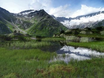 Scenic view of snowcapped mountains against sky