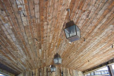 Low angle view of light hanging from ceiling of building