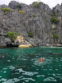 Scenic view of sea against rock formation