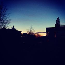 Silhouette of buildings against clear sky